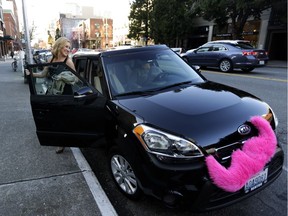 A woman gets out of a Lyft car in Seattle, where Uber is suing the city for passing a law allowing Uber drivers to unionize.