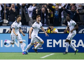 Vancouver Whitecaps' Fredy Montero, from left to right, Tim Parker and Alphonso Davies celebrate Montero's goal against the New York Red Bulls during second half CONCACAF Champions League quarter-final soccer action in Vancouver, B.C., on Thursday, March 2, 2017.