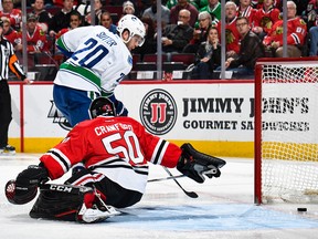 Brandon Sutter of the Canucks scores on Corey Crawford of the Blackhawks in the second period at the United Center.