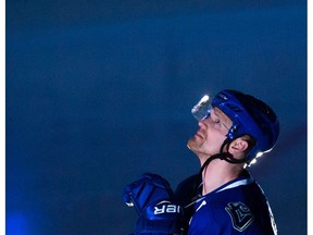 Henrik Sedin watches a video presentation while being recognized for recording his 1,000th career point last month, before playing the Minnesota Wild in an NHL hockey game, in Vancouver on Saturday, February 4, 2017.