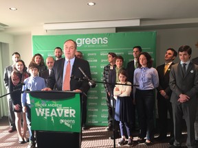 BC Green leader Andrew Weaver unveils his party's climate change platform while flanked by candidates and others in Victoria.