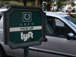 In this 2016 photo, a driver waits to pick up passengers at an Uber and Lyft pick-up area at the Bellagio hotel and casino in Las Vegas.