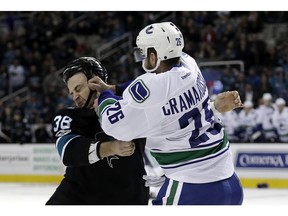 Vancouver Canucks' Joseph Cramarossa, right, fights with San Jose Sharks' Micheal Haley during the first period of an NHL hockey game Thursday, March 2, 2017, in San Jose, Calif.