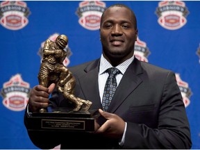 B.C. Lions offensive tackle Jovan Olafioye holds the trophy for Most Outstanding Offensive lineman trophy as he poses for photographers during the CFL awards show in Toronto Thursday, November 22, 2012. The Montreal Alouettes have acquired all-star international offensive tackle Olafioye from the B.C. Lions for the rights to national offensive tackle David Foucault.