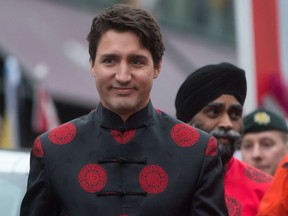 Prime Minister Justin Trudeau and Defence Minister Harjit Sajjan, back right, attend the Chinese Lunar New Year parade in Vancouver, B.C., on Sunday, January 29, 2017.