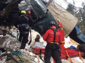 Search and rescue crews work to remove a driver trapped in the cab of his truck about 200 metres down an embankment in Manning Park on March 2. The man was rescued after a 10-hour operation, but died later in hospital.