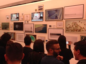 A contingent of international journalists in a gallery at the Carrousel du Louvre in Paris on Tuesday, checking out a wall of new TV’s named The Frame, from Samsung. When it’s not a TV set it shows art, and could be easily mistaken for a framed print hanging on the wall.