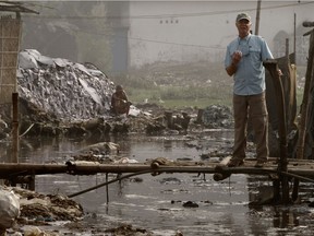 Mark Angelo stands on a small bridge in the heart of the extremely polluted Dhaka leather district in the Bangladesh capital.