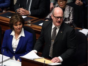 Premier Christy Clark looks on as B.C. Finance Minister Mike de Jong waits to deliver a balanced budget for a fifth year in a row at the legislature in Victoria on Feb. 21.