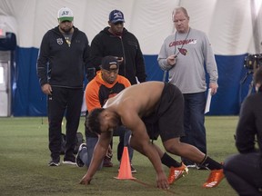 Three local football players, who have received interest from NFL scouts, are put through drills during Pro Day at the North Shore bubble complex in North Vancouver, BC Friday, March 10, 2017. Pictured are scouts watching player Jordan Herdman.