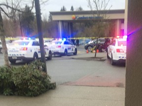 Surrey RCMP at the scene of a fatal shooting outside a Comfort Inn hotel at Fraser Highway and 166th Street Monday afternoon.