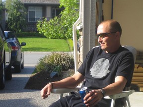 The late Surrey firefighter Ernie Dombrowski, who tragically took his own life two years ago, is shown in a contemplative moment four years ago after cutting the family's lawn.