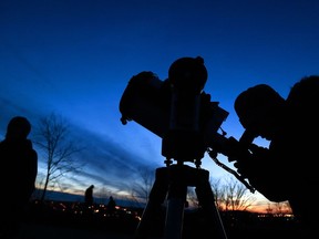 The sun sets atop Armour Hill as Boyd Wood sets up his telescope to get a glimpse of the Sirius star Saturday as the Peterborough (Ont.) Astronomical Association invited those of all ages to view the stars. The association celebrated its ninth annual Earth Hour from 8:30 p.m. local time until midnight.