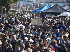 People attend the annual 4/20 marijuana event at it's new location at Sunset Beach on April 20, 2016.