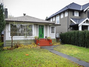 An older house sits next to a large modern house, a typical scene in Vancouver's Dunbar neighbourhood.