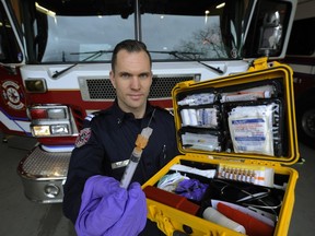 ‘We used to see huge spikes on income assistance Wednesdays and the day or two after ... but now when we look at the numbers, that spike is diminished,’ says Vancouver Fire Department Capt. Jonathan Gormick, pictured last year holding a naloxone kit for reviving overdose victims. ‘And it's not that the spike has gone down, it's because every other day is just as busy.’