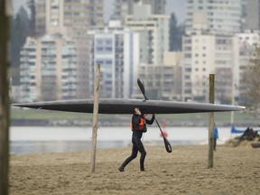 Grey skies and cool weather kept the crowds away — but not this kayaker — from Kitsilano Beach on Vancouver’s west side on Monday afternoon.