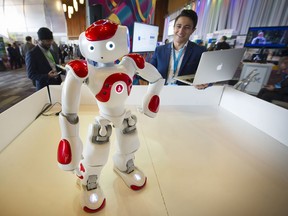 A Robot with "Attitude". Nizar Mohamed looks over "NAO" a new brain IBM cognitive robot put through his paces at the B.C. Tech Summit inside of Canada Place convention centre on March 14, 2017.
