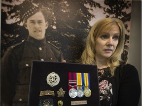 Carol Madill beside her grandfather's photograph inside the Seaforth Armouries hall. Sgt. Major George Soles won three Distinguished Conduct Medals, the most ever won by a Canadian solider.