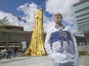 Artist Douglas Coupland with his sculpture The Golden Tree.