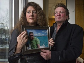 Margie and Mark Gray hold a picture Thursday, March 10, 2016 of their son Myles Gray, who was killed by VPD in August 2015 under suspicious circumstances.