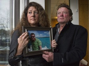 Margie and Mark Gray hold a photo on March 10, 2016, of their son Myles Gray, who died after an altercation with Vancouver police in August 2015.