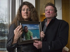 FILE PHOTO Margie and Mark Gray hold a picture Thursday, March 10, 2016 of their son Myles Gray, who was killed by VPD in 2015 under suspicious circumstances.