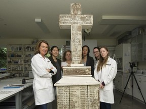 Sarah Spafford-Ricci, far left, with the team who restored the Seaforth Highlanders' Vimy Ridge memorial cross, in Surrey on Thursday.