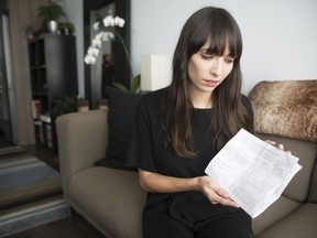 Marijuana activist Jodie Emery returned to Vancouver after being released from a Toronto jail. Emery is subject to a number of conditions as listed on the document she's holding.