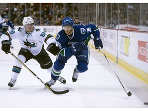 Vancouver Canucks right wing Jannik Hansen (36) fights for control of the puck with San Jose Sharks center Chris Tierney (50) during first period NHL action Vancouver, B.C. Saturday, Feb 25, 2017.