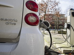 An electric car uses a public charging station, 959 Mainland Street  Vancouver February 23, 2016.