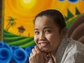 Hessed Torres, in front of one of her paintings, is a nanny from the Philippines.