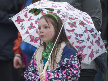 Emily Coyle watches the De Danaan Dancers perform at the Celtic Fest set up on Robson st to celebrate St. Patrick's Day Vancouver March 17 2017.