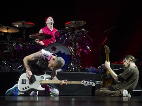Red Hot Chili Peppers bass guitarist Flea (left), drummer Chad Smith (centre) and lead guitarist Josh Klinghoffer (right) open the concert at Vancouver's Rogers Arena as part of the Gateway World Tour, March 18, 2017.