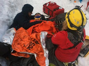 North Shore Rescue medical personnel work on a skier who triggered an avalanche in the back country near the Cypress ski area on March 4, 2017, and was swept over a small cliff and buried. His companion was able to dig out his face so he could breathe until rescuers arrived. The man was seriously injured and was flown by the rescue team's helicopter directly to a park near Lions Gate Hospital in North Vancouver.