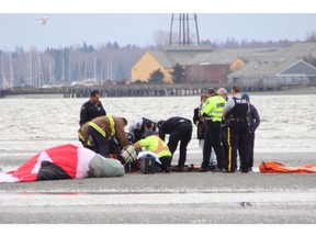 Rescue crews on the scene of a motorized para-glider crash on White Rock beach.