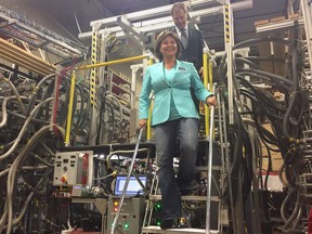 B.C. Liberal leader Christy Clark climbs down a plasma injector during a campaign stop at General Fusion, a tech company in Burnaby.