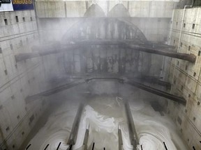 Water pours from the base and a cloud of water vapor and concrete dust forms as a massive tunneling machine nears breaking through a five-foot wide concrete wall into the disassembly pit for the State Route 99 highway, Tuesday, April 4, 2017, under Seattle. After tunneling more than 9,000 feet and building an outer tunnel wall as it moved forward, the boring machine finished digging what will be a two-mile, double-decker traffic tunnel to replace the Alaskan Way viaduct, damaged in an earthquake