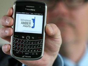 Calgary Sun Photo-Telus's ,Chris Gerritsen, holds up his phone as The federal government and Canada's wireless telecommunications industry are teaming up to send Amber Alerts to cellphones. The wireless Amber Alert program, launched Wednesday, is free for anyone who signs up and is operational in all ten provinces and three territories..... DARREN MAKOWICHUK/QMI AGENCY