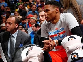 Oklahoma City Thunder guard Russell Westbrook sits on the bench with ice on his knees against the Denver Nuggets during the first half of an NBA basketball game, Sunday, April 9, 2017, in Denver. (AP Photo/Jack Dempsey)