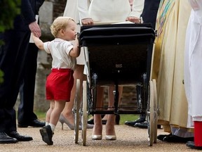 FILE - In this Sunday, July 5, 2015 file photo, Britain&#039;s Prince George gets up on tiptoes to peek into the pram of Princess Charlotte flanked by his parents Prince William and Kate the Duchess of Cambridge as they leave after Charlotte&#039;s Christening at St. Mary Magdalene Church in Sandringham, England. Kensington Palace said Monday April 10, 2017 that George, 3, and Charlotte, 1, will be page boy and bridesmaid at the May 20 nuptials of Middleton and financier James Matthews. (AP Photo/Matt Dun