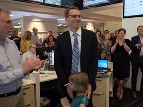 Washington Post editor Martin Barron, left, joins the paper&#039;s staff in congratulating David Fahrenthold, center, upon learning that he won the Pulitzer Prize for National Reporting, for dogged reporting of Donald Trump&#039;s philanthropy, in the newsroom of the Washington Post in Washington on Monday, April 10, 2017. (Bonnie Jo Mount/The Washington Post via AP)