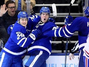 FILE - In this Feb. 25, 2017, file photo, Toronto Maple Leafs&#039; Auston Matthews (34) and teammate William Nylander (29) celebrate after Matthews&#039; second goal during the third period of an NHL hockey game against the Montreal Canadiens, in Toronto. Canada is back in the Stanley Cup playoffs. The buzz is back north of the border with five of the nation‚Äôs seven teams making the playoffs a year after the hockey-mad country was shut out. (Frank Gunn/The Canadian Press via AP)