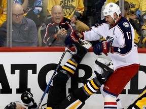 Columbus Blue Jackets&#039; Brandon Dubinsky (17) collides with Pittsburgh Penguins&#039; Ron Hainsey (65) during the first period in Game 2 of an NHL first-round hockey playoff series in Pittsburgh, Friday, April 14, 2017. (AP Photo/Gene J. Puskar)