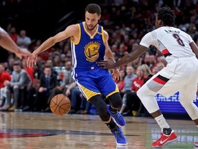 Golden State Warriors guard Stephen Curry, left, dribbles around his back past Portland Trail Blazers forward Al-Farouq Aminu during the first half of Game 4 of an NBA basketball first-round playoff series, Monday, April 24, 2017, in Portland, Ore. (AP Photo/Craig Mitchelldyer)