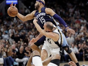 San Antonio Spurs guard Manu Ginobili (20) and Memphis Grizzlies guard Vince Carter (15) battle for a loose ball during the first half of Game 5 in a first-round NBA basketball playoff series, Tuesday, April 25, 2017, in San Antonio. (AP Photo/Eric Gay)