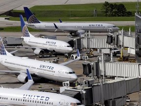 FILE - In this July 8, 2015, file photo, United Airlines planes are parked at their gates as another plane, top, taxis past them at George Bush Intercontinental Airport in Houston. United Airlines says it will raise the limit to $10,000 on payments to customers who give up seats on oversold flights and will increase training for employees as it deals with fallout from the video of a passenger being violently dragged from his seat. (AP Photo/David J. Phillip, File)
