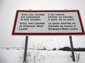 A sign is seen near Emerson, Man. Thursday, February 9, 2016. The Manitoba and federal governments have been unable to resolve a dispute over refugee funding because they cannot agree on how many claimants walking across the U.S. border stay in the province. The Progressive Conservative government asked for federal help in Feburary to provide housing, education and others services for an influx of asylum seekers crossing entering the country near Emerson, Man. Education Minister Ian Wishart said