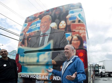 British Columbia NDP Leader John Horgan jokes around with NDP candidate Ravi Kahlon as they check out the leader's campaign bus in North Delta, B.C, Monday, April, 10, 2017.