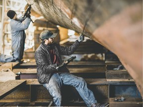 A man wears clothing from the Seattle-based brand Filson as he works at the Pacific Fisherman Shipyard in this undated handout photo.